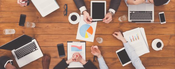 Group of busy business people meeting in office, top view